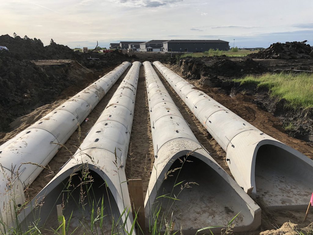 Precast concrete pipe in a field