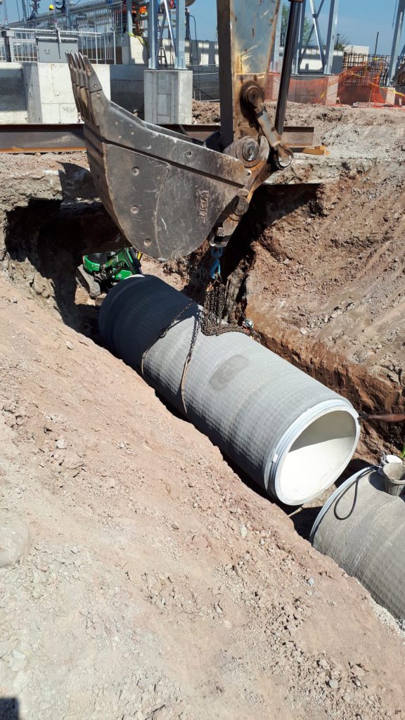 concrete pipe being laid at construction site