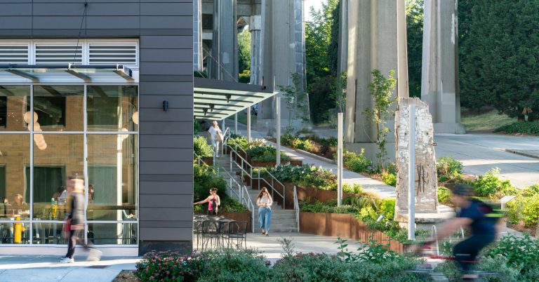 beautiful outside view of office building with gardens and greenery