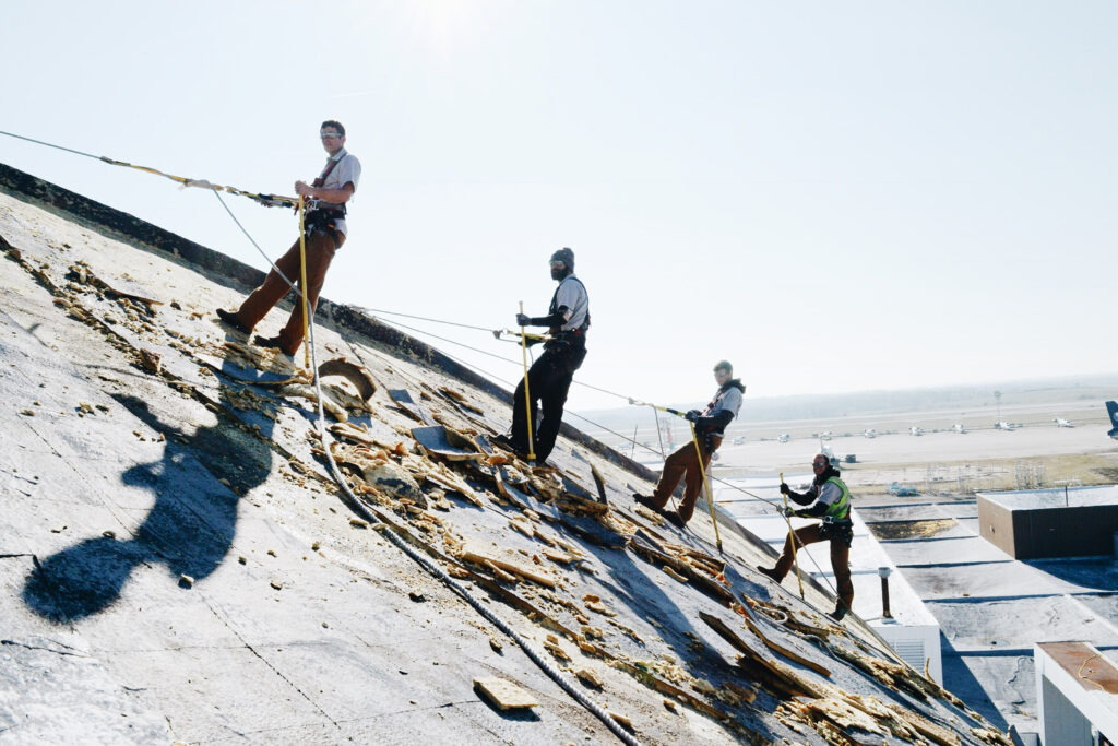 JR & Co. workers on roof of building