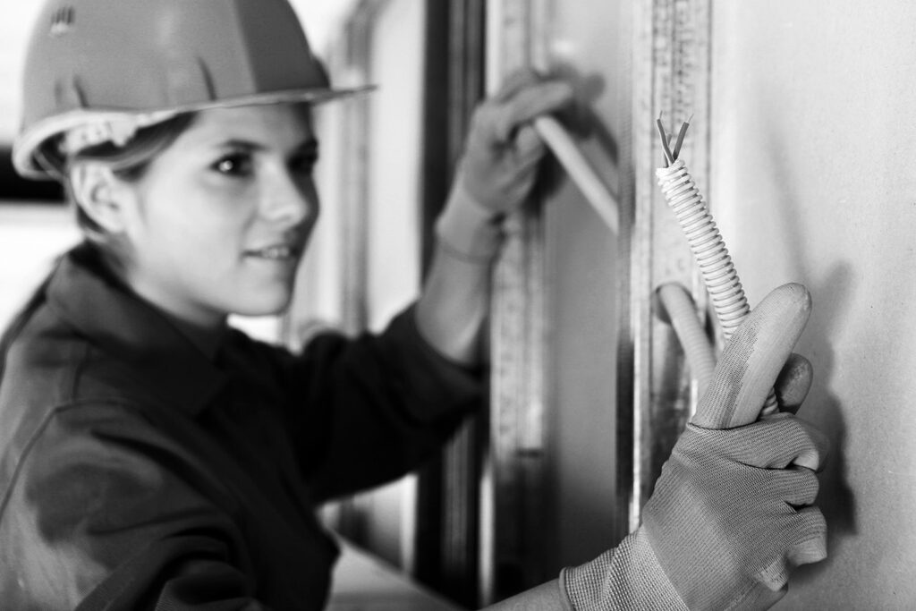 skilled trades woman installing electrical wiring