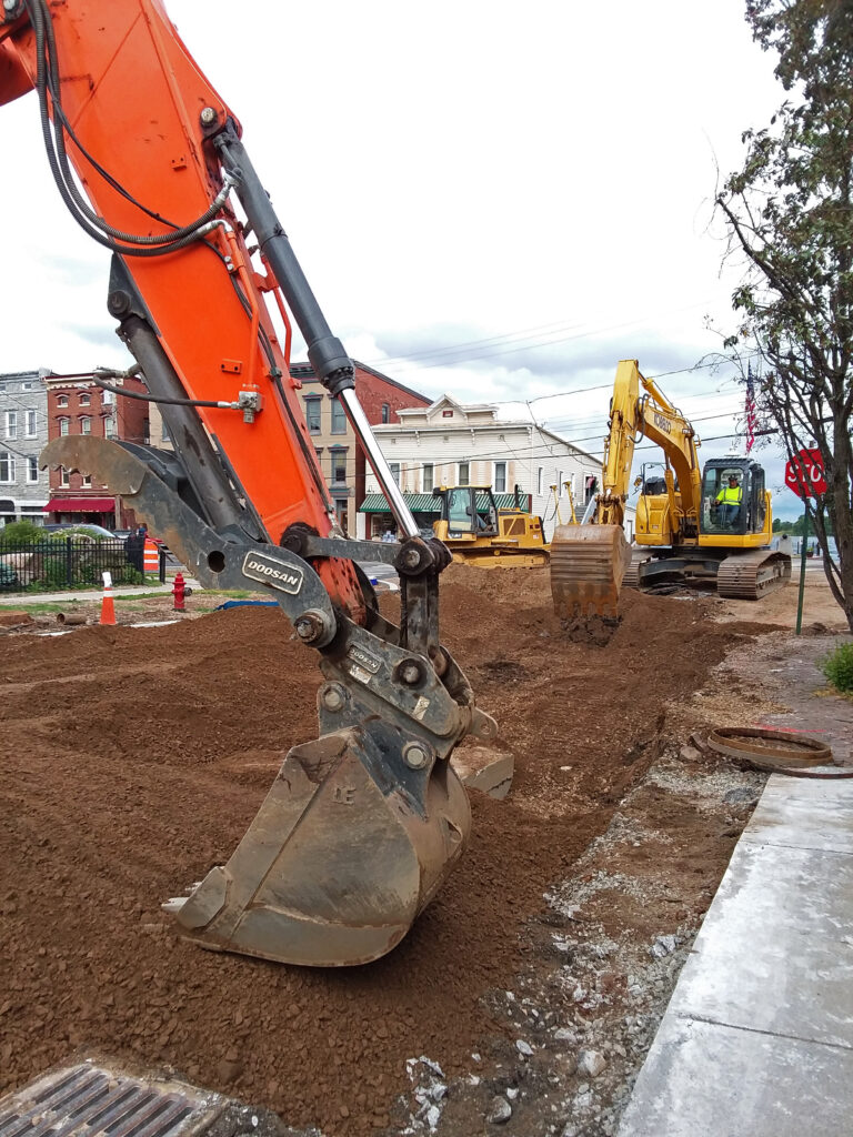 luck bros road construction with excavator buckets