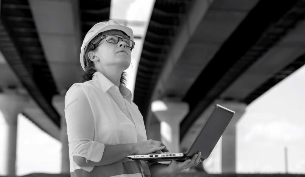 female construction worker under bridge jobsite