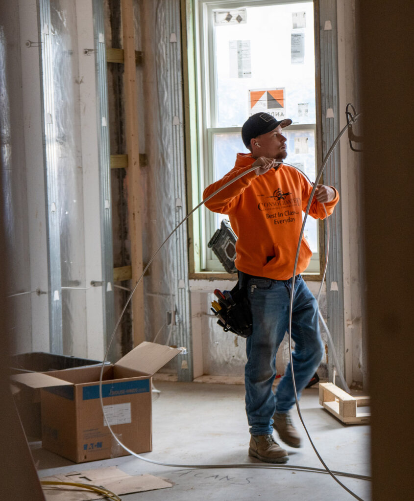 consolidated electrical worker in building installing electrical