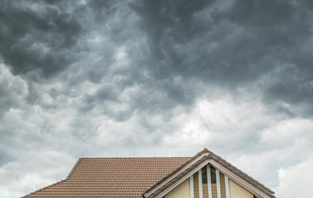 storm climate change concept above house roof