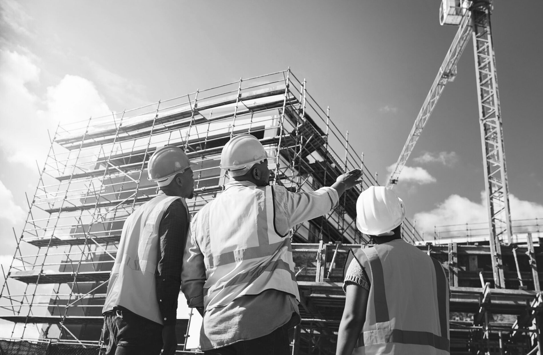 Engineering, construction site and team outdoor for building project, planning and architecture. Black woman and men contractor together for development and safety assessment discussion in city