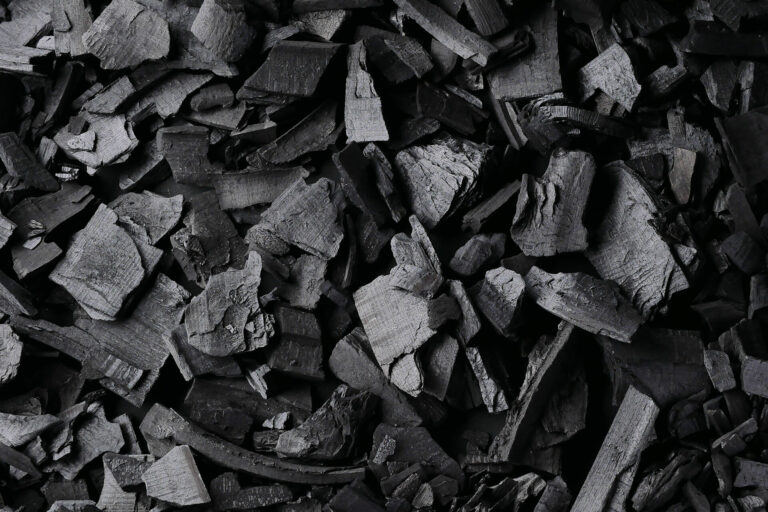 Black charcoal texture background. Close-up