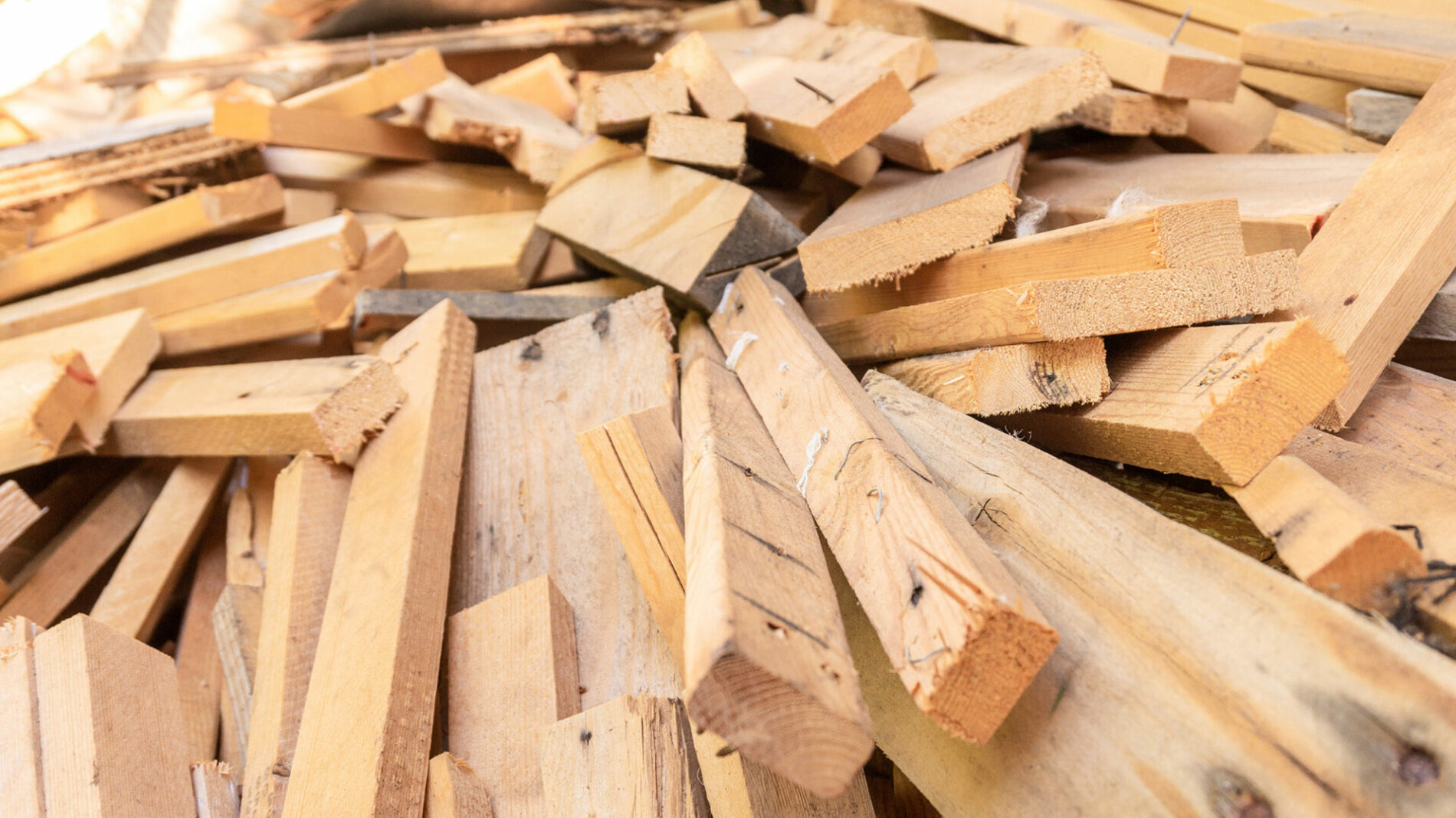 Pile of scrap wood from mattresses and palettes for recycled (up-cycled) DIY furniture making or wood carpentry projects. Wood cuts for practice or rustic craft ideas. Environmental resource saving.