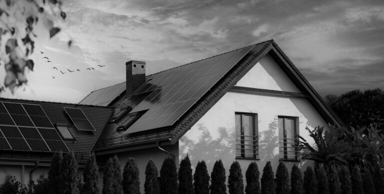 Solar panels on a gable roof. Large modern house and solar energy. Sunset.