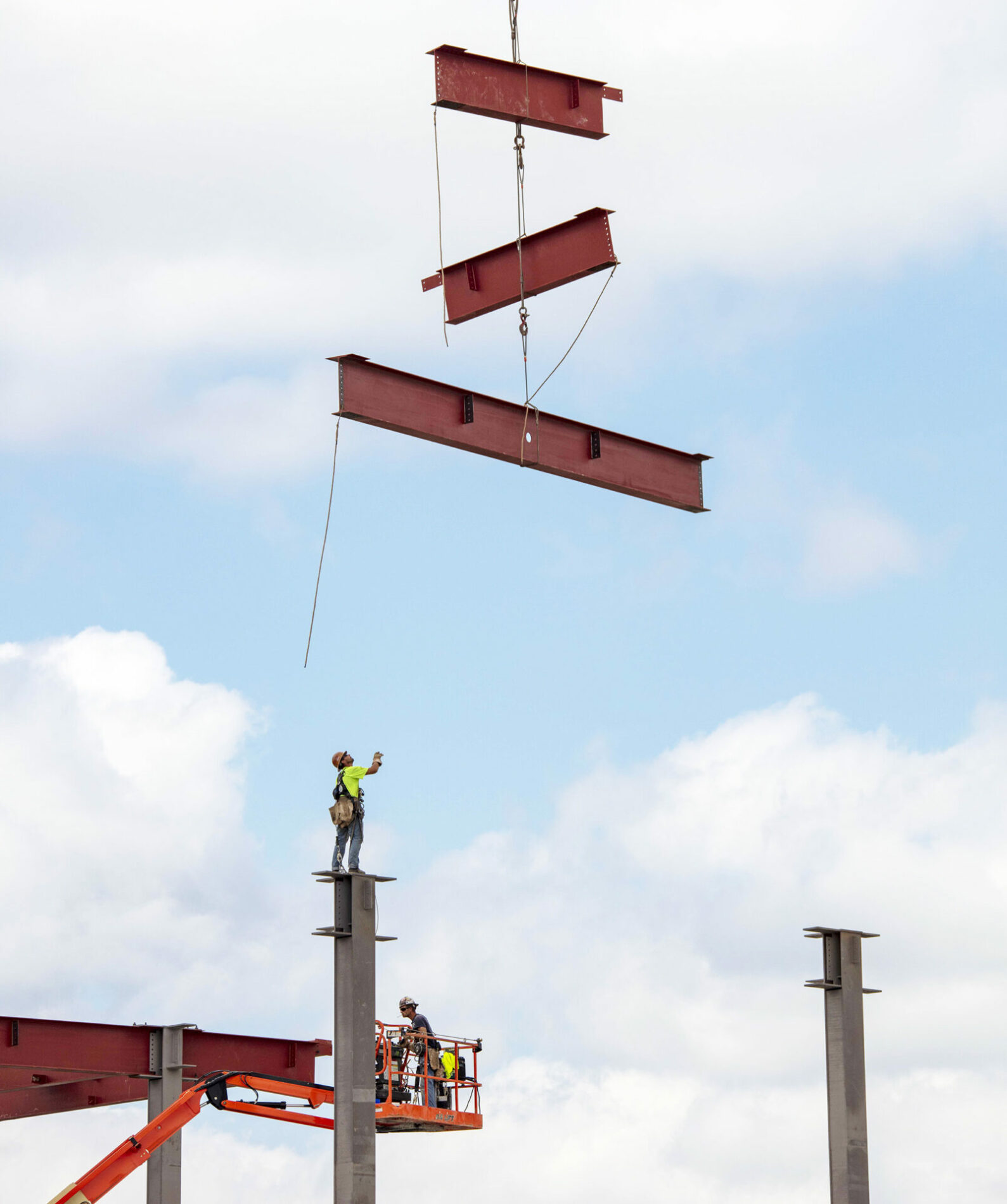 A photo of a crane lowering steel.