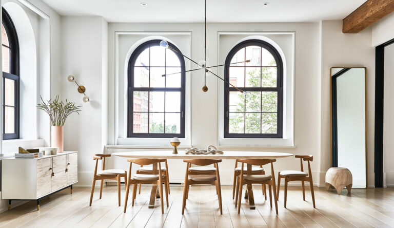 Beautiful, bright room with tall arched windows and soft colour tones.