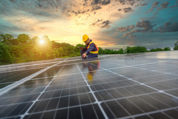 A power plant engineer installs solar panels To inspect the solar panels, engineers use tablets Technology for renewable energy and sustainability Future sources of alternative energy